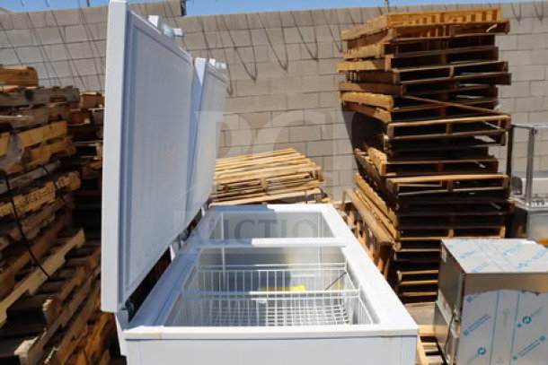 Brand new Galaxy CF30HC commercial chest freezer, 30 cu. ft., 115 volts, with cosmetic scratches/dents. Lid open, wire baskets visible.