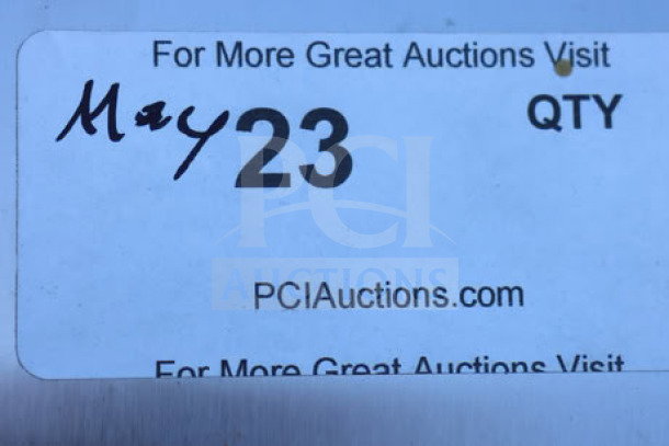 Sticker label from PCI Auctions with "May 23" handwritten, indicating auction date.