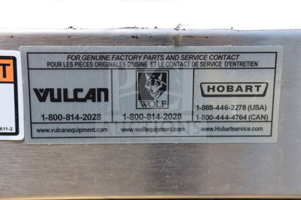 Alt text: Close-up of service contact label on Vulcan VC5ED electric convection oven, showing brands Vulcan, Wolf, and Hobart.