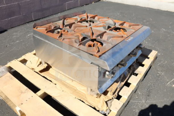 Cooking Performance Group R-CPG-24-NL 4 burner gas countertop range, 88,000 BTU, with surface rust, on a pallet.