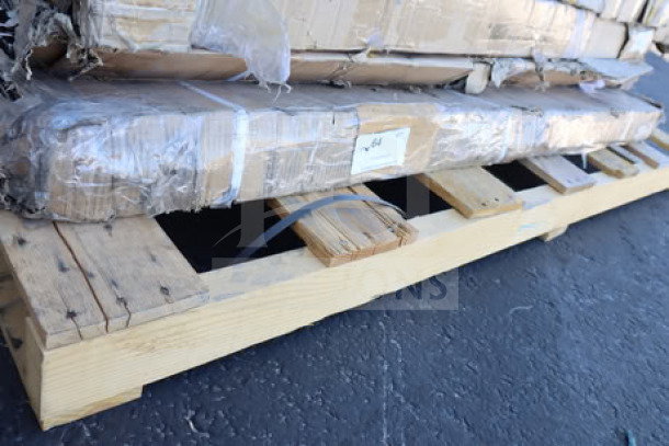 Wooden work table disassembled on a pallet, wrapped in protective packaging. Condition appears good, no visible labels.