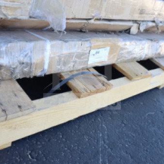 Wooden work table disassembled on a pallet, wrapped in protective packaging. Condition appears good, no visible labels.