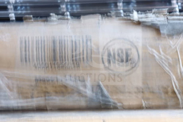 Blurry image of a work table packaging with an NSF mark visible, indicating standard compliance.