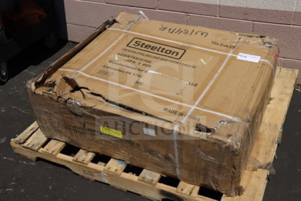 Steelton 522EBTKD3036D stainless steel table in damaged box on pallet. Features 16 gauge type 430 enclosed base with sliding door.