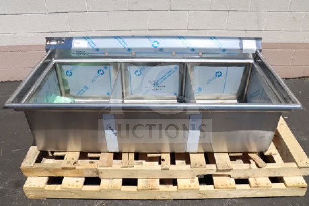 Brand new Aero MF3-2420 3-compartment sink with 7" backsplash, 16 gauge stainless steel, faucet holes, on a wood pallet.