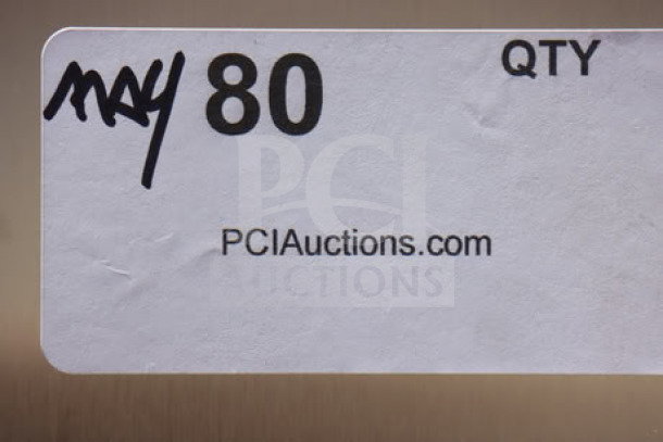 "May 80" sticker on stainless surface with PCIauctions.com displayed.