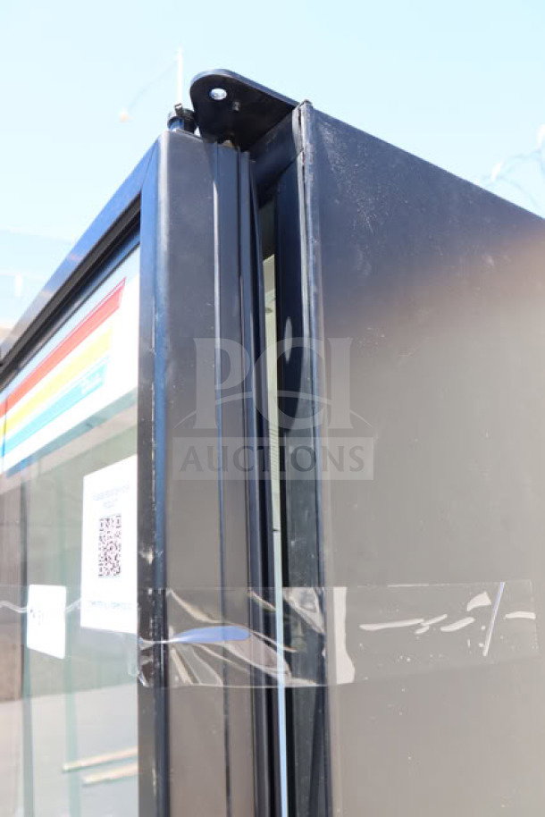 New True FLM-54 TSL01 black refrigerated merchandiser, LED lighting, glass door, tested, working, S/N: 11273464.