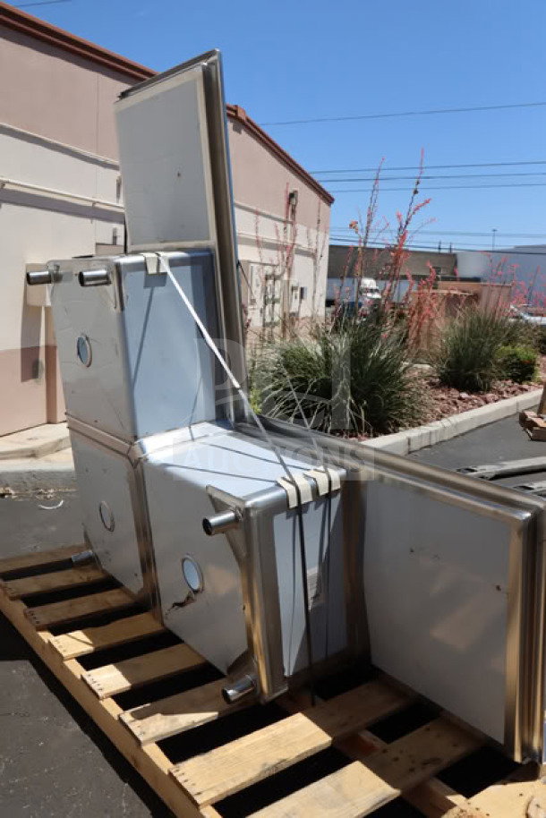 Brand new Regency 600S3242424C commercial corner sink with three compartments and two 24" drainboards on a pallet.