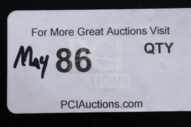 Sticker label from PCI Auctions with handwritten May 86 and "QTY" printed, promoting more auctions on their website.