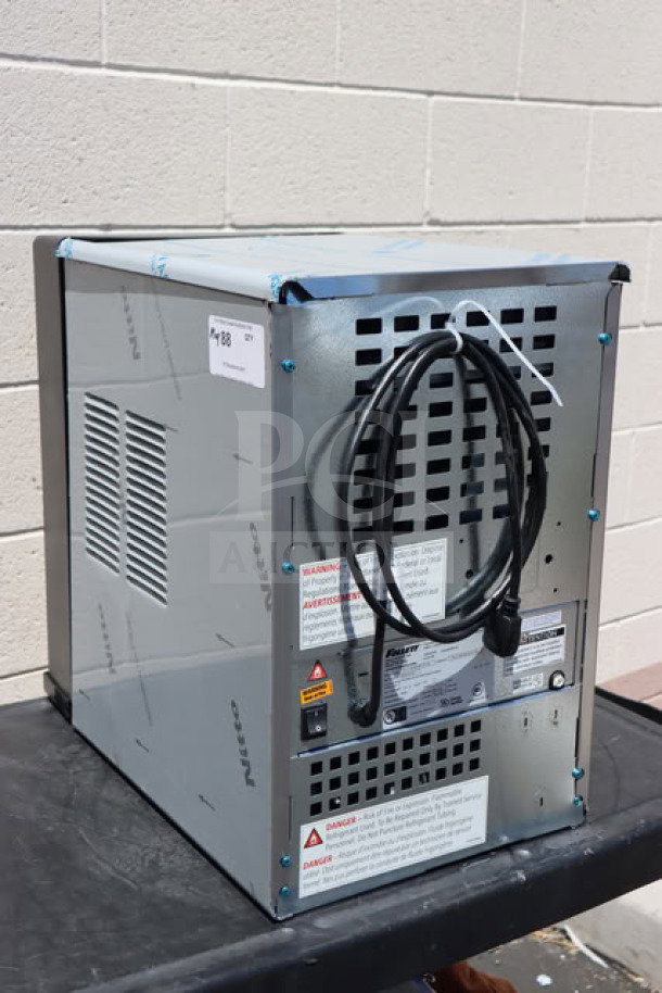 BRAND NEW Follett 15CI114A-IW-NF-ST-00 countertop ice maker, minor dents visible, with labels and power cord shown.