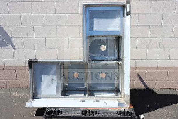 Brand new Regency 600S31620C 57" three-compartment corner sink with two 18" drainboards, scratch-n-dent condition.