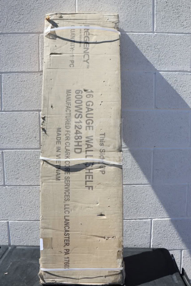 Regency 600WS1248HD 16 Gauge Stainless Steel 12" x 48" Wall Shelf, new in box, visible labeling on packaging.