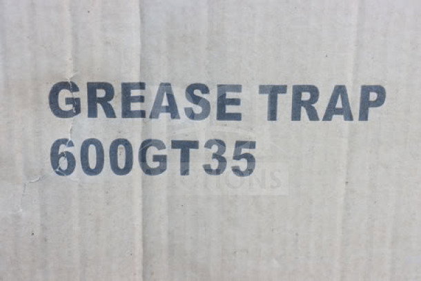 "Box with 'GREASE TRAP 600GT35' text, indicating a new Regency 600GT35, 70 lb., 35 GPM grease trap inside."