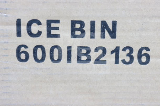 Regency 600IB2136 ice bin label on ripped packaging. Stainless steel underbar model, 21"x36", holds 119 lbs.