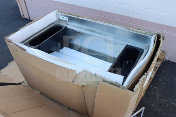 Regency 600IB2136 stainless steel underbar ice bin, 21" x 36", with bottle holders. Packaging ripped, item new.