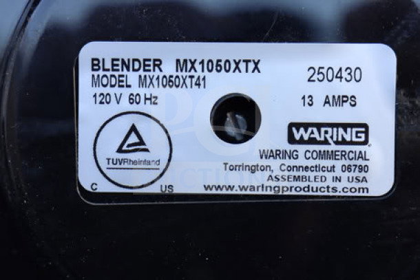 Waring MX1050XTS blender label, shows model MX1050XTX, 120V, 60 Hz, 13 amps. Assembled in USA, TUV Rheinland certified.