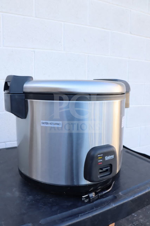 Brand new Galaxy 177RCSGB60 rice cooker, 60 cup capacity, stainless steel, 120V, 1550W. Caution label on exterior.