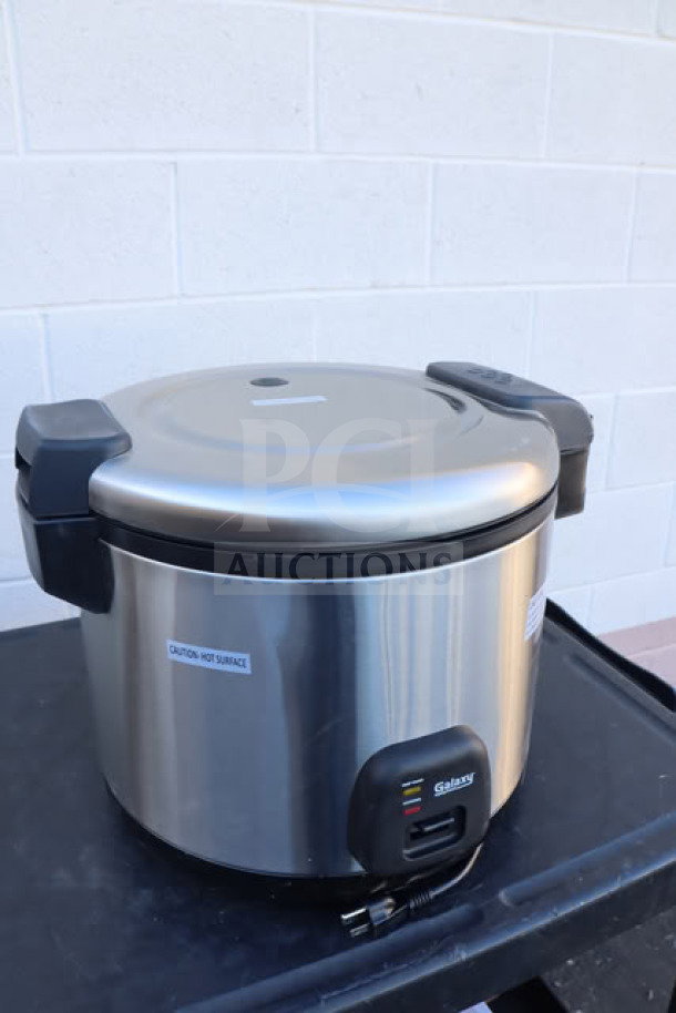Brand new Galaxy 60 Cup Electric Rice Cooker/Warmer, Model 177RCSGB60, stainless steel, 120V, 1550W, with caution label.