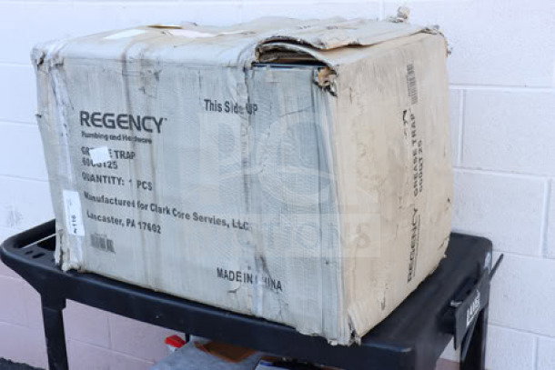 Brand new Regency 600GT25 grease trap in damaged original packaging. PDI certified, 50 lb. capacity, 25 GPM, 3" non-threaded connections.