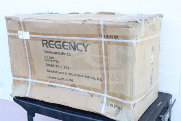 Regency 600IB2136 Ice Bin in original, unopened box. Box shows signs of wear. Holds 119 lbs. Stainless steel with bottle holders.