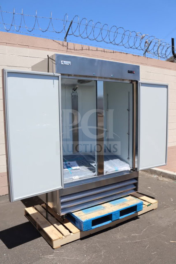 Brand new Avantco A-49F-HC 54" reach-in freezer, stainless steel, solid doors open, on pallet, minor scratches visible.