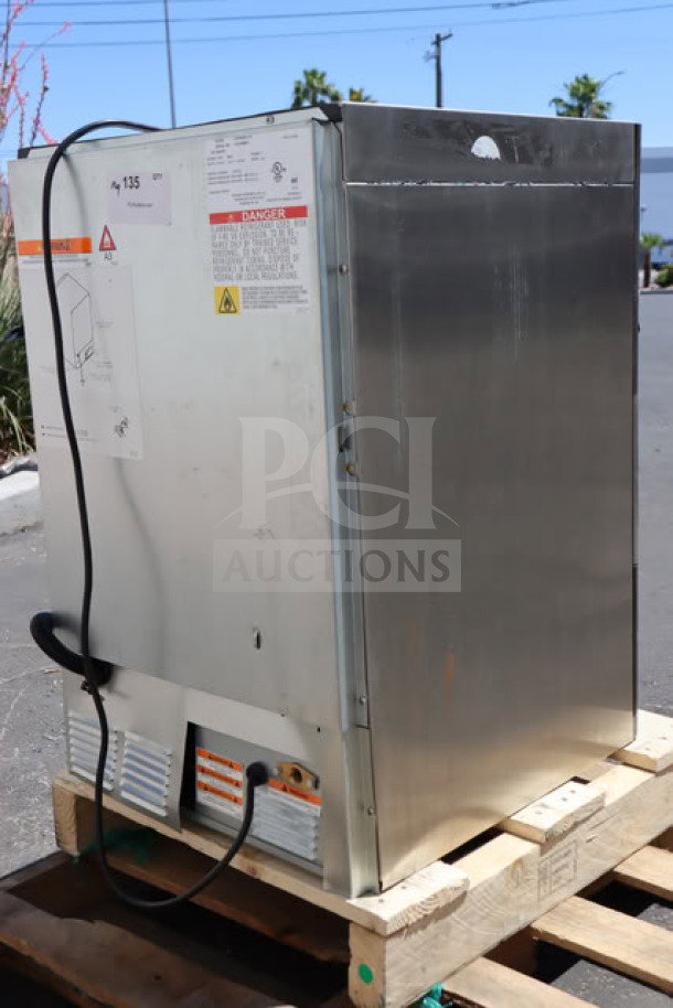Brand new Manitowoc UDP-0080A ice machine, air cooled, 31 lb bin, minor scratches shown, labels detail safety info.