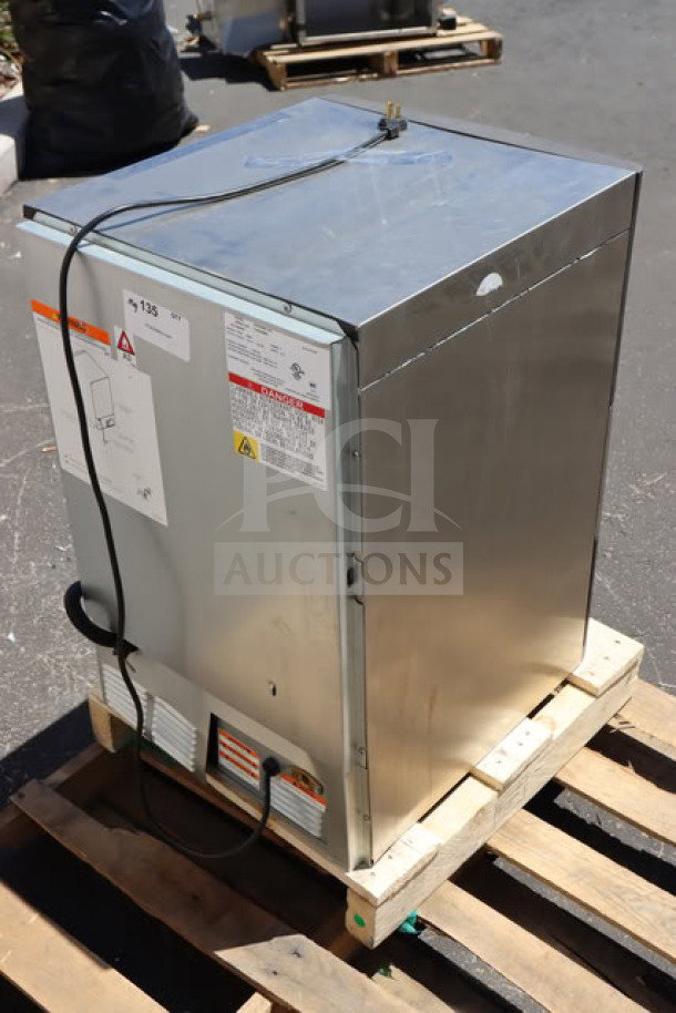 Brand new Manitowoc UDP-0080A undercounter ice machine, 19 11/16" air-cooled, scratch-n-dent. Labels with safety warnings visible.