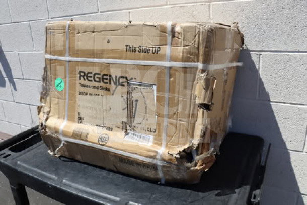 Regency 18"x24" stainless steel drop-in ice bin, model 600DIIB1824, in damaged original packaging.