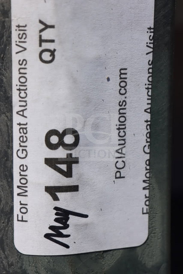 Sticker label on cart leg showing auction site info and number 148.