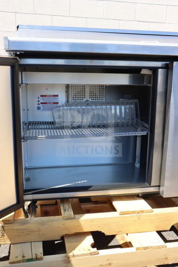 Brand new True TSSU-60-16-HC refrigerated sandwich prep table, 60 3/8", 2 doors, tested, shows some scratches.