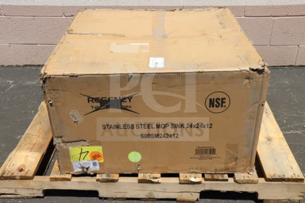BRAND NEW Regency 600SM242412 stainless steel mop sink, 24"x24"x12" bowl, original packaging damaged, on a pallet.