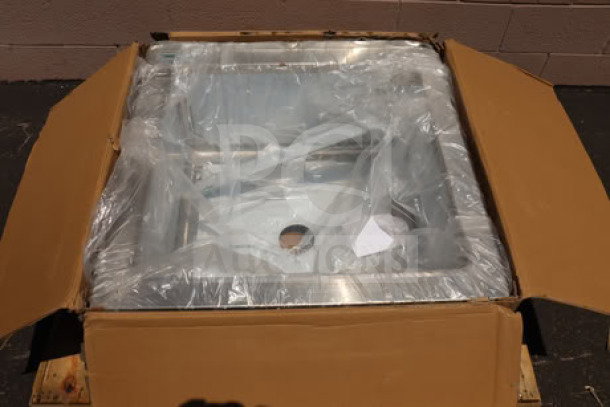 Brand new Regency 600SM242412 stainless steel mop sink in damaged packaging. Size: 24"x24"x12" bowl, 16-gauge steel.
