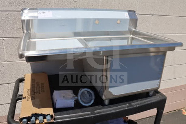 Brand new Steelton 522CS11818L 38 3/4" commercial sink with 18" left drainboard, visible minor scratches and dents.