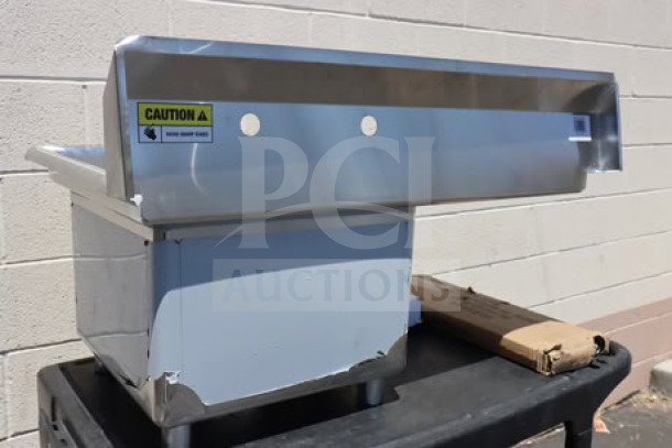 Brand new Steelton 522CS11818L commercial sink with 18" left drainboard, scratch-and-dent, with caution label.