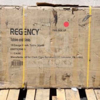 BRAND NEW Regency 600TS3048S 30" x 48" stainless steel work table in damaged original packaging; model and specs visible.