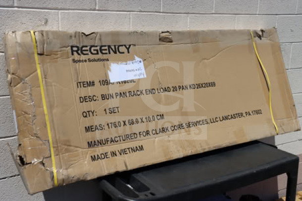 Brand new Regency 109APR1820L 20 Pan End Load Bun/Sheet Pan Rack in original packaging; features non-marking casters.