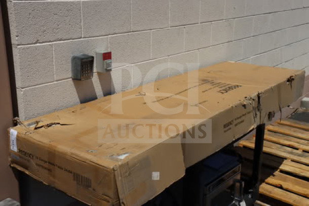 Regency 600TB2484G stainless steel work table in original packaging, featuring 24"x84"x18 gauge size, with backsplash, galvanized legs, and undershelf.