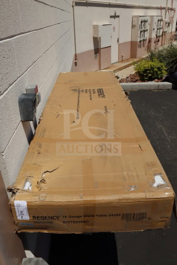 Regency 600TB2484G stainless steel work table, new in box. Features 24" x 84" size, 4" backsplash, galvanized legs.