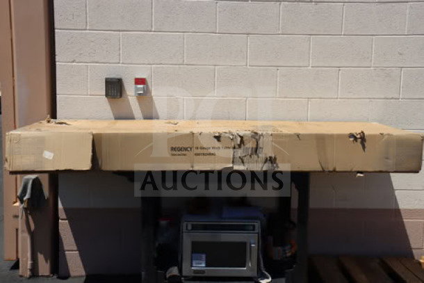 BRAND NEW Regency 600TB2484G stainless steel work table in original packaging, features 4" backsplash, galvanized legs, undershelf.