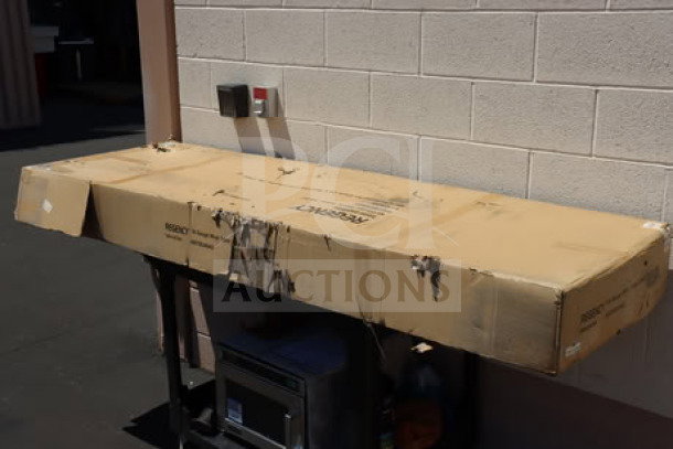 Brand new Regency 600TB2484G stainless steel work table in original packaging, includes 4" backsplash, galvanized legs, and undershelf.