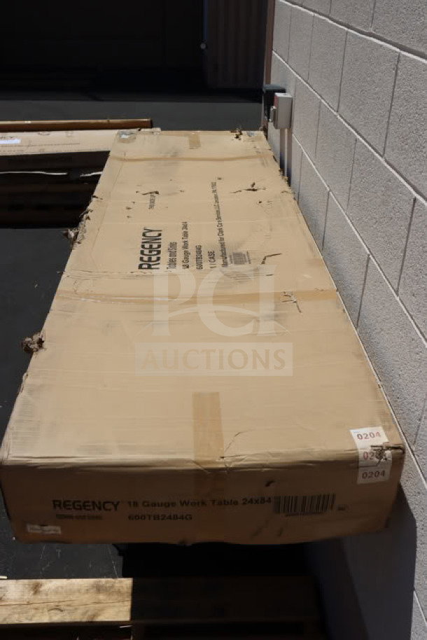 BRAND NEW Regency 600TB2484G work table, 24" x 84", in original packaging. 18-gauge stainless steel, galvanized legs, with backsplash.