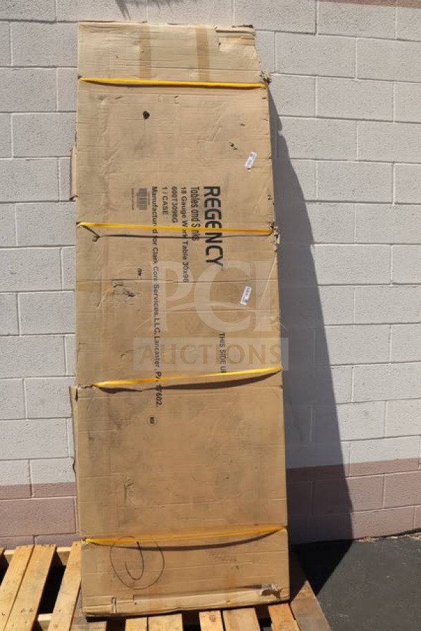 BRAND NEW Regency 600T3096G 30" x 96" stainless steel work table in original packaging with visible label and details.