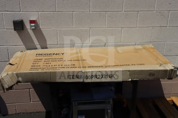 Regency 600PR20316K 20 Pan End Load Bun/Sheet Pan Rack in original, damaged packaging.