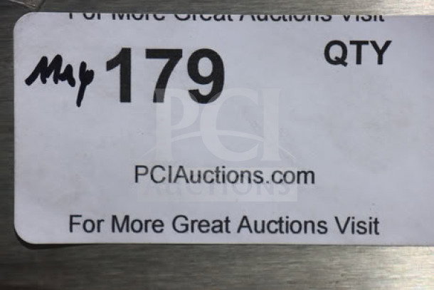 Sticker label showing "May 179 QTY" with "PCIAuctions.com" and a prompt for more auctions, placed on a surface.