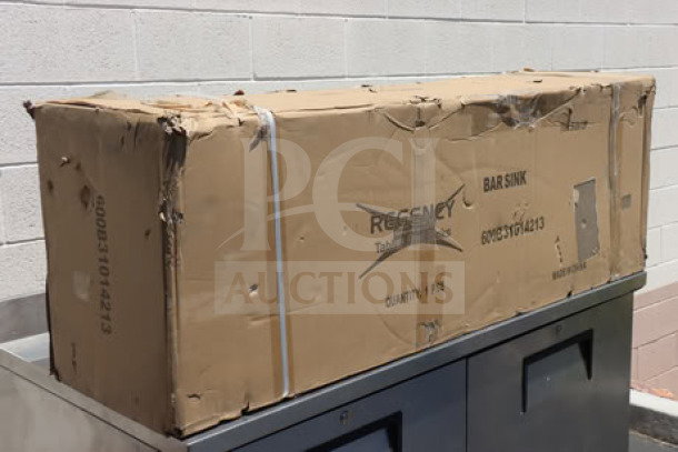 Brand new Regency 60" x 18 3/4" three-bowl underbar sink with two drainboards, model 600B31014213, in damaged packaging.