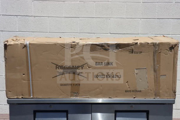 "Brand new Regency 60-inch three-bowl underbar sink with two drainboards in damaged packaging. Model 600B31014213."