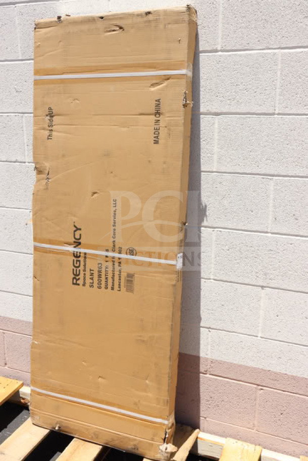 Brand new Regency 600WR63 63" wall-mounted slanted rack shelf in original packaging, showing model and brand markings.