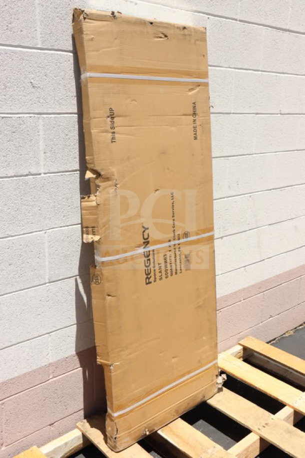 Brand new Regency 600WR63 63" wall-mounted slanted rack shelf in original packaging, casing shows slight wear.