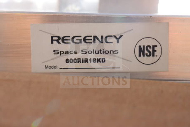 Regency 600RIR16KD label on unassembled aluminum pan rack. Original packaging damaged, may be missing small parts.