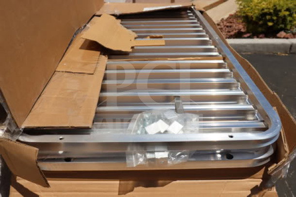 Regency 600RIR16KD 16 Pan Aluminum Rack, unassembled, visible packaging damage, possibly missing parts.